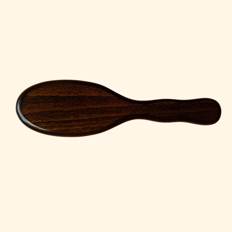 Wooden brush on a beige background