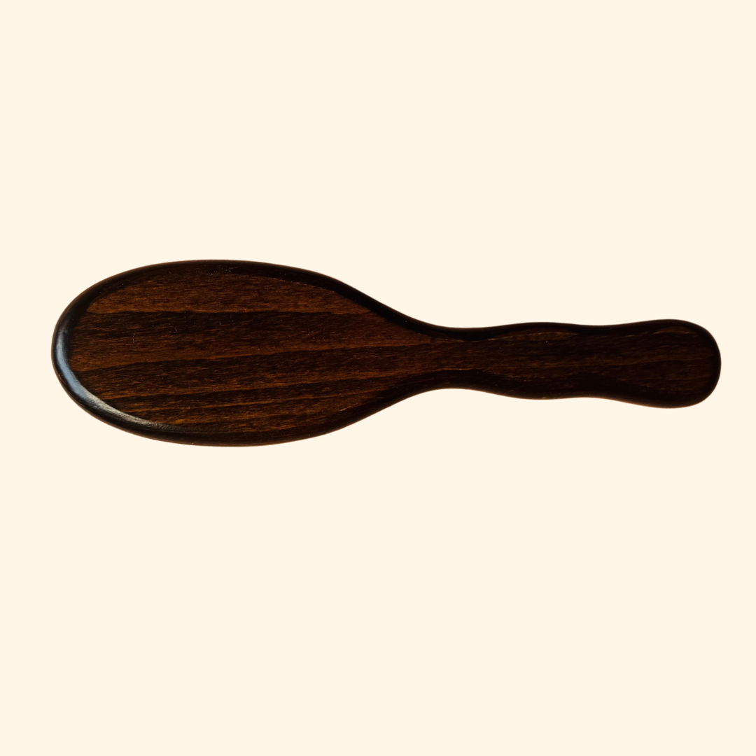 Wooden brush on a beige background